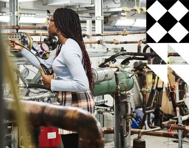 Young black woman working in an engineering lab.
