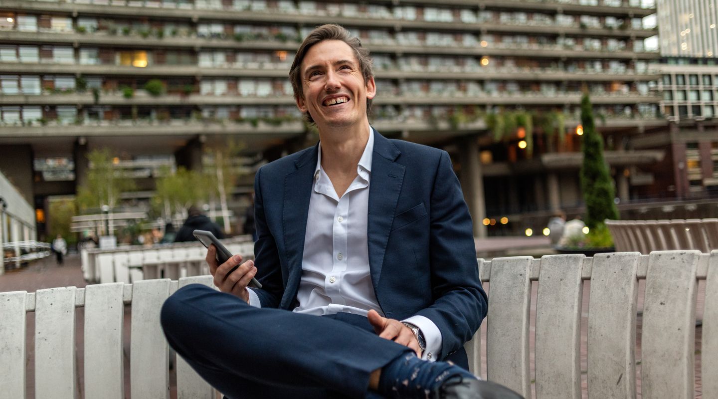 Student smiling on bench