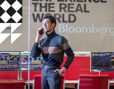 Male business student on the phone in the Bloomberg computer suite
