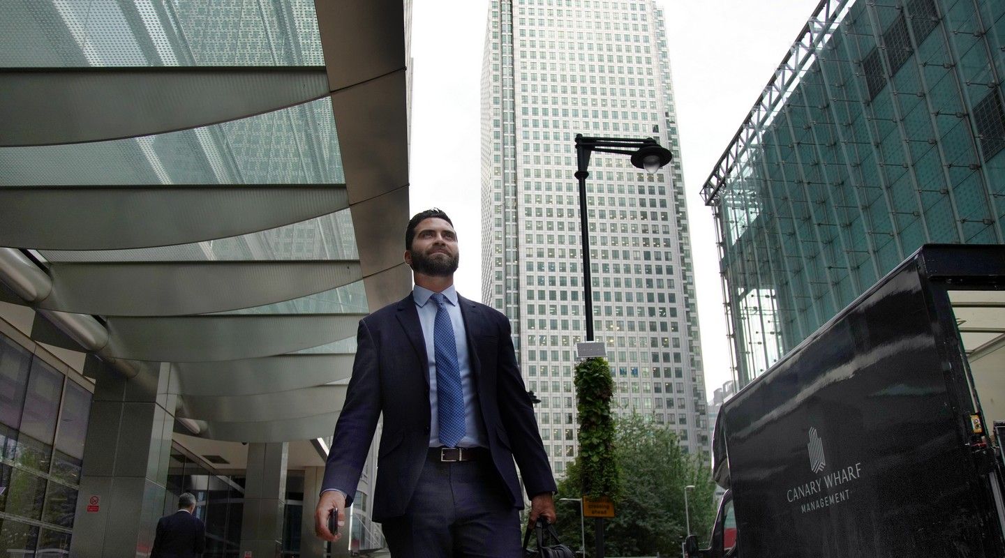 A City alumnus walking in Canary Wharf