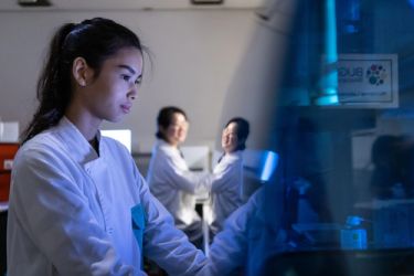 Image of a person working in a genomic medicine lab