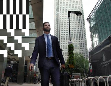 A City alumnus walking in Canary Wharf