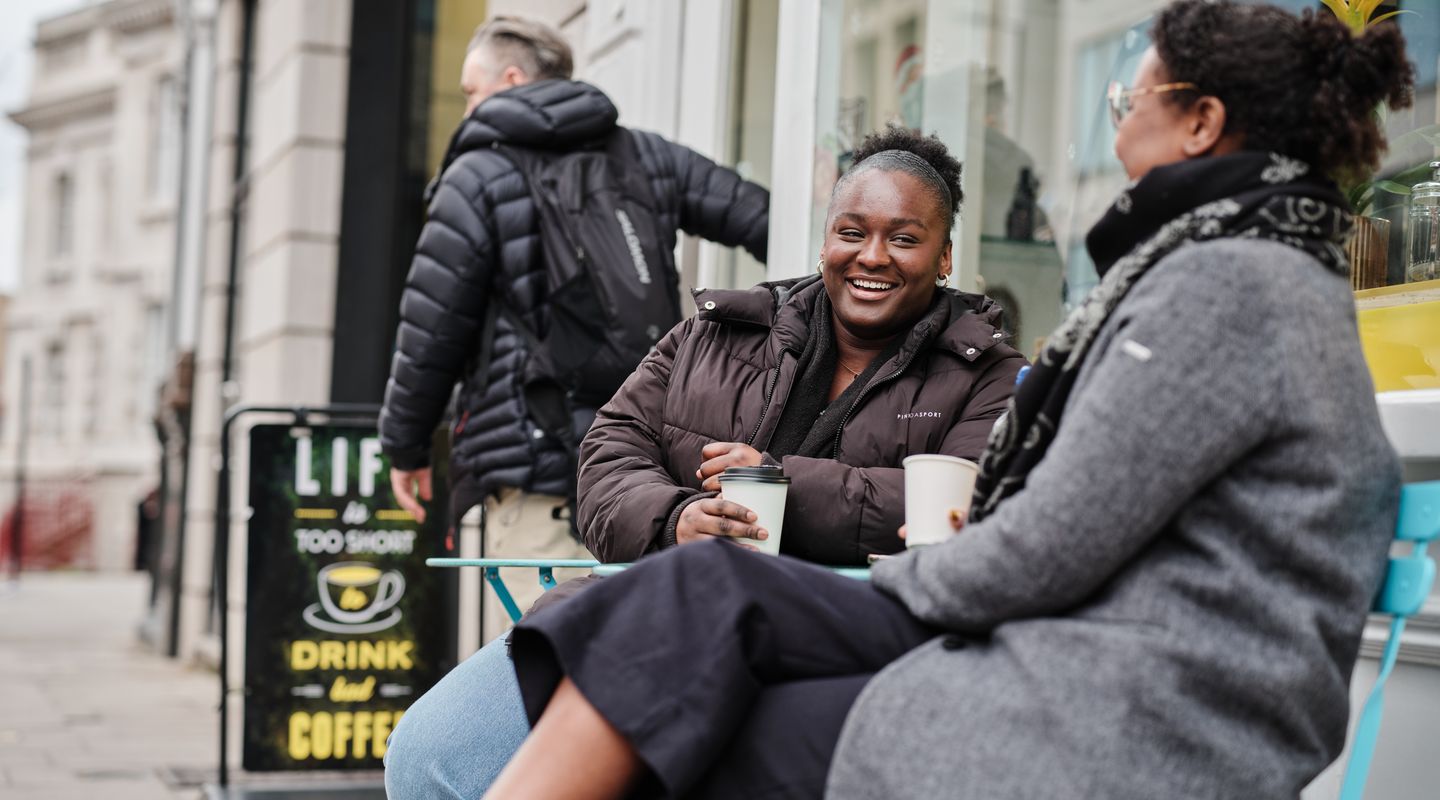 City students drinking coffee and laughing