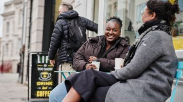 City students drinking coffee and laughing