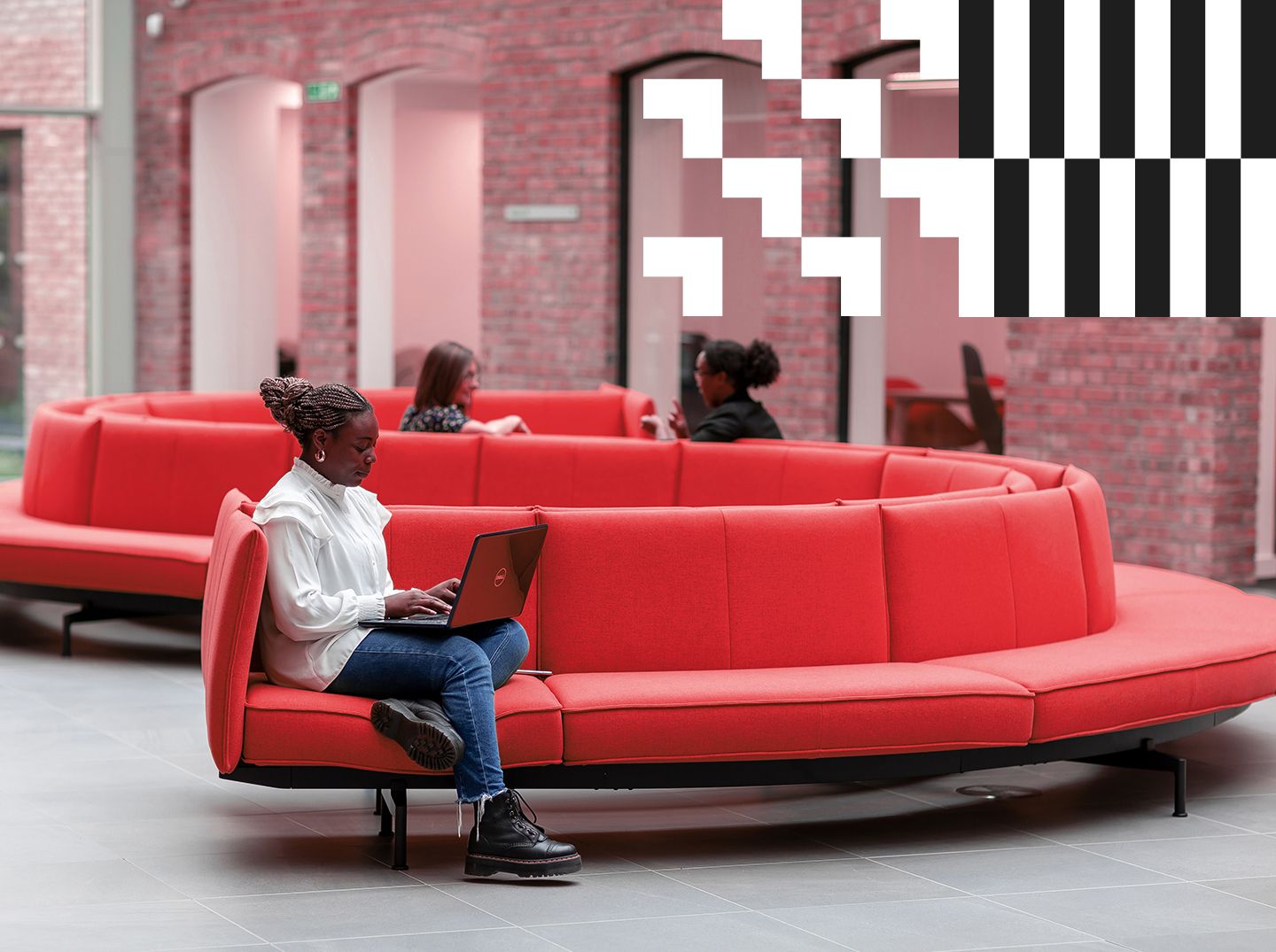 Student sitting on a couch with a laptop