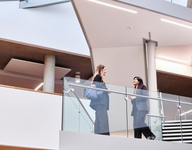 Two girls on the stairs in the Law Building 