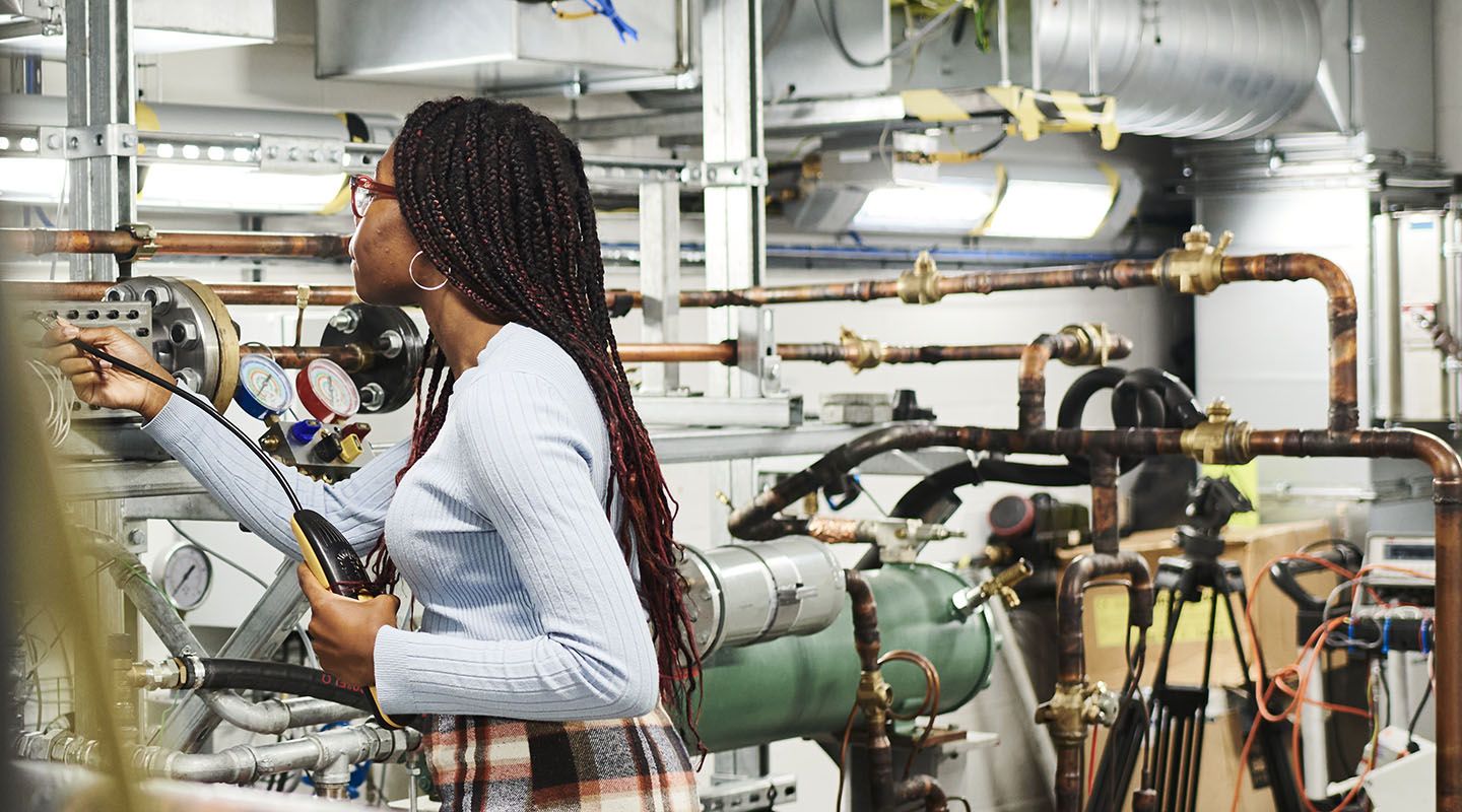 Young black woman working in an engineering lab.