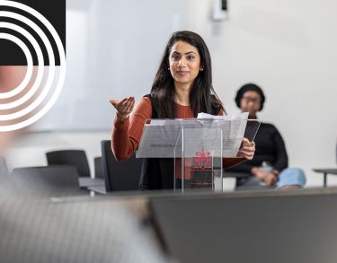 Female law student infront of courtroom podium debating