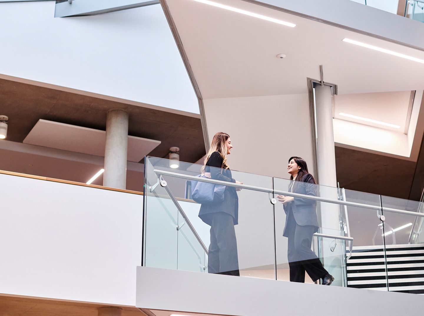 Two girls on the stairs in the Law Building 
