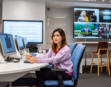 Female student sat in the multimedia suite