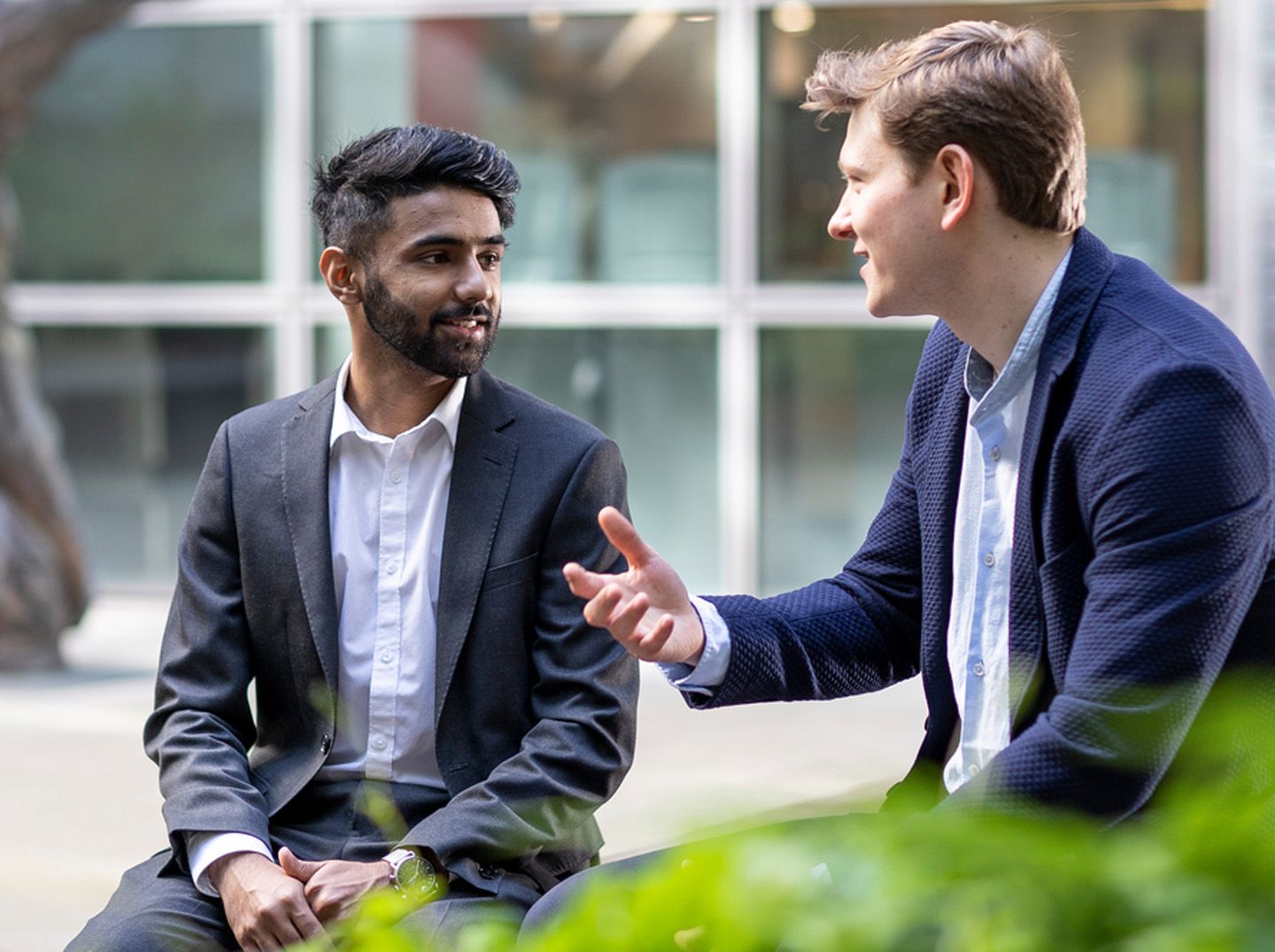 Two male students talking outside 