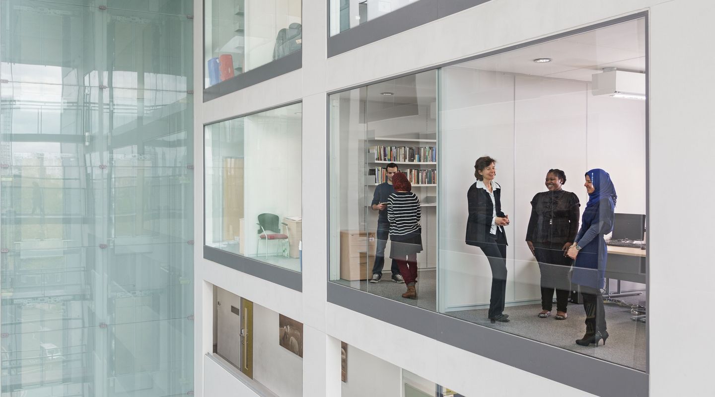 Rhind Building - group of people near an internal glass window