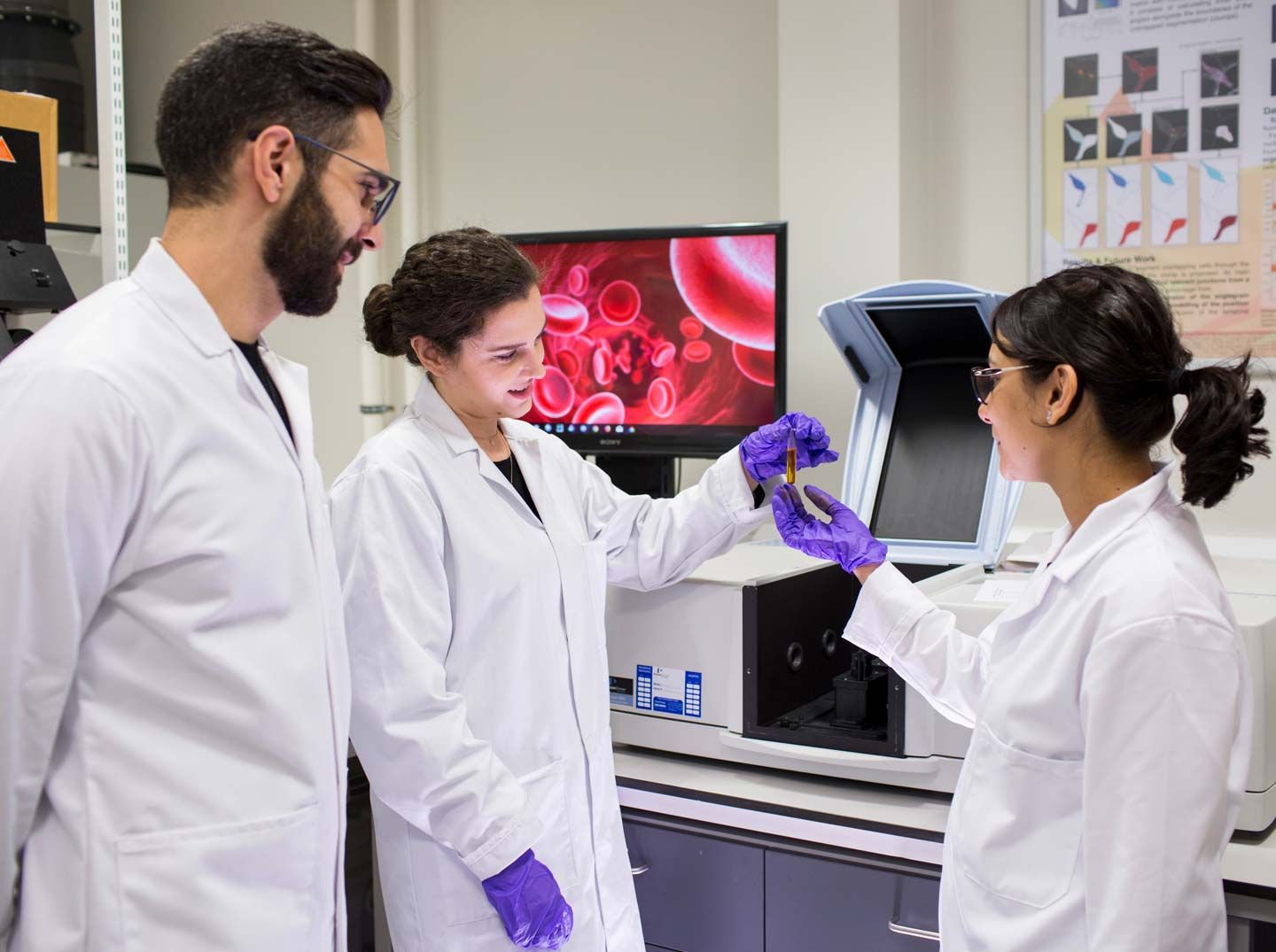 Three students in the bioengineering lab at City, University of London.