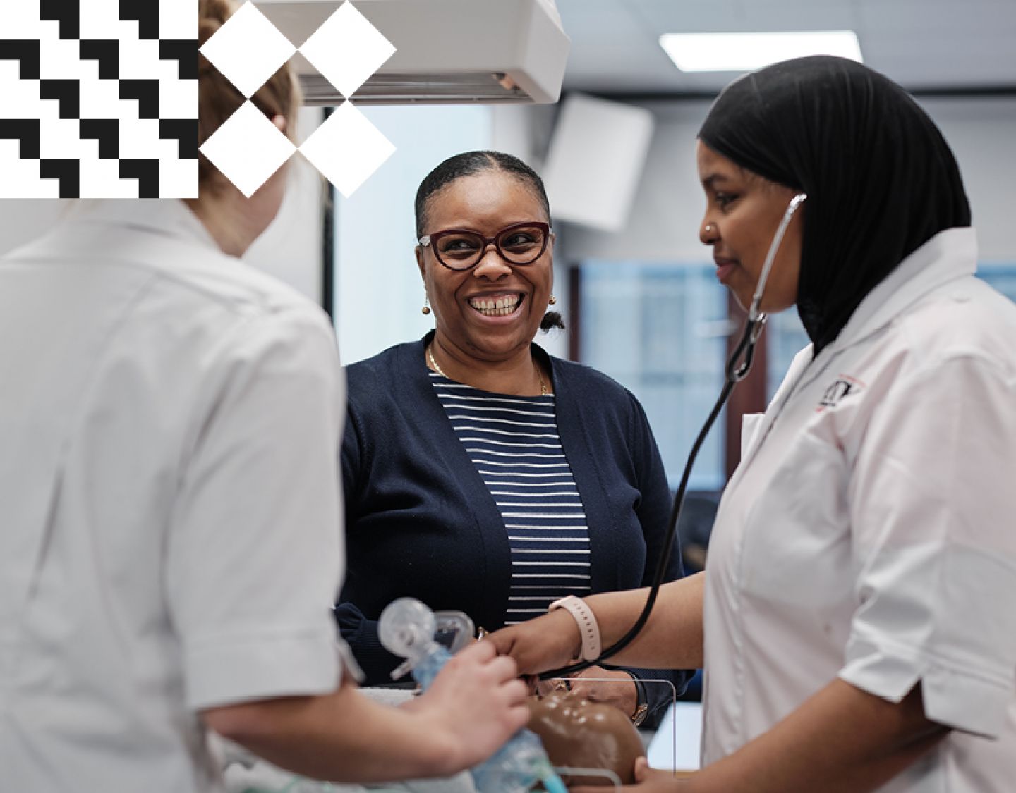 Academic smiling as student nurses conducts stethoscope exam using dummy patient