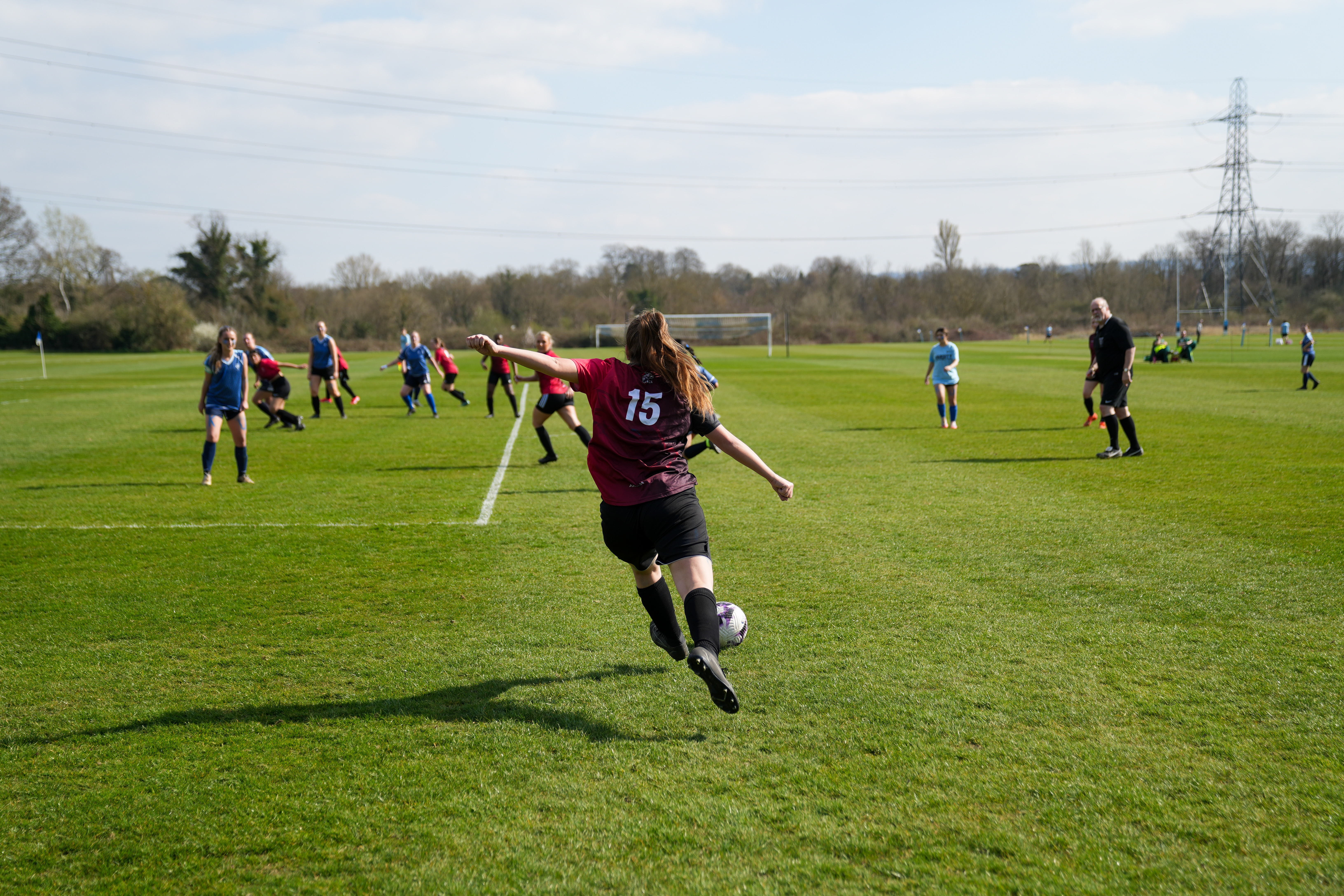 Woman playing football on a pitch