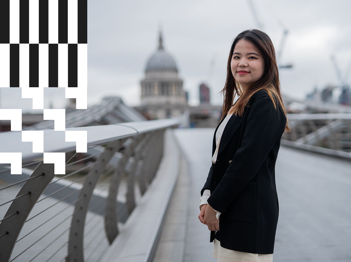 A City alumna standing at the Millennium Bridge