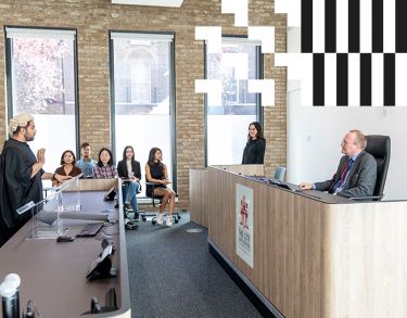 Academic and students in the mooting room