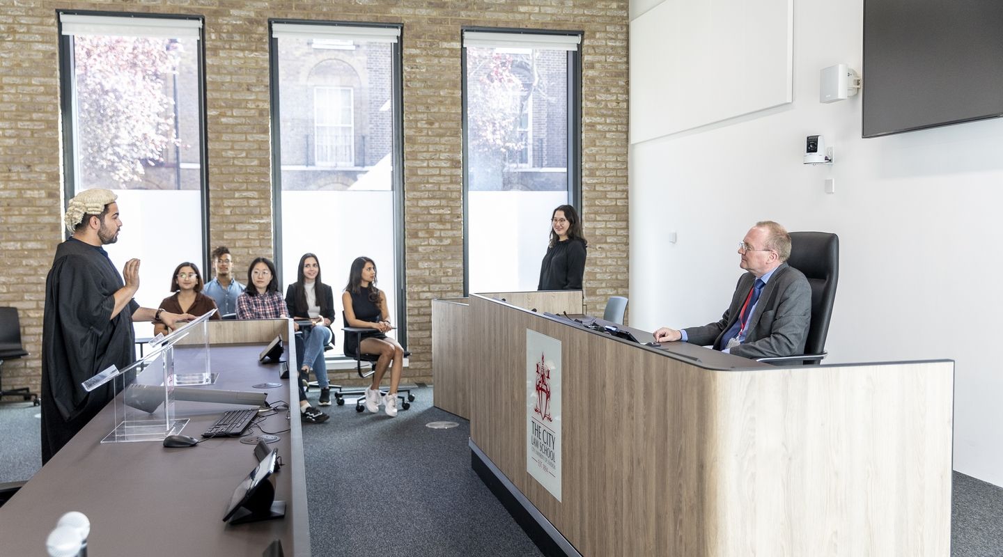 Academic and students in the mooting room