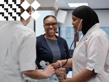 Academic smiling as student nurses conducts stethoscope exam using dummy patient