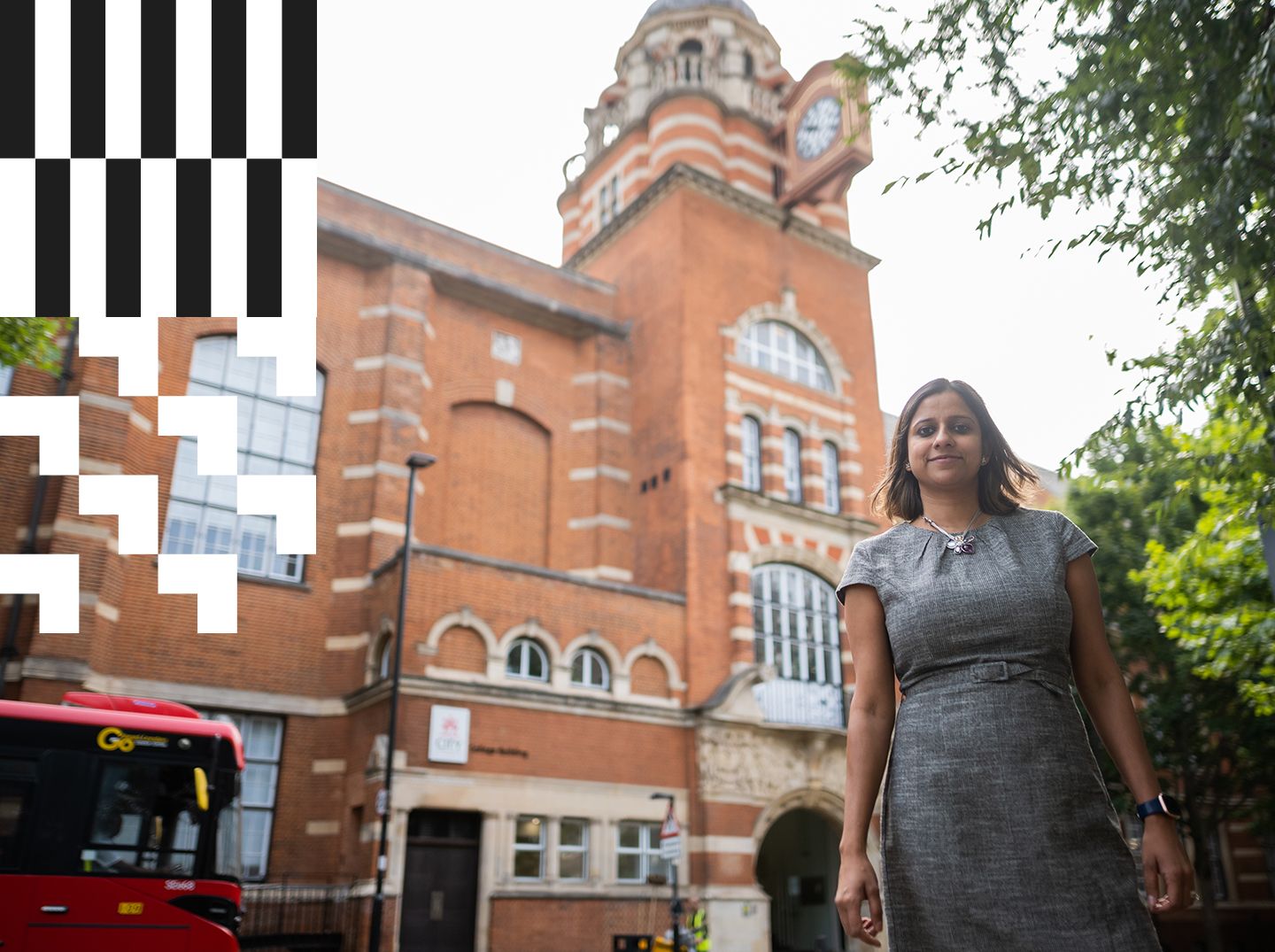 A City alumna standing near College Building