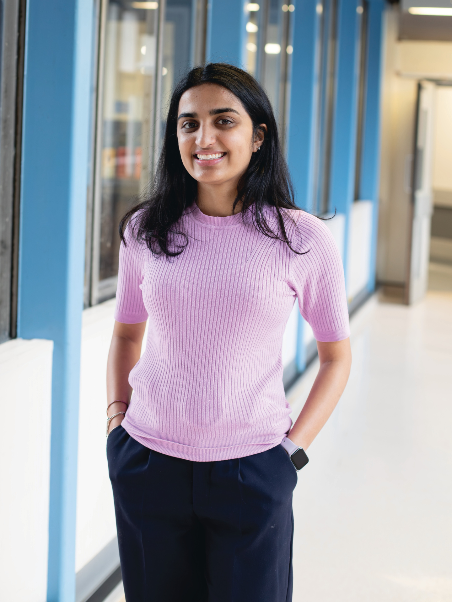 Photo of Anusha, a student standing in a corridor