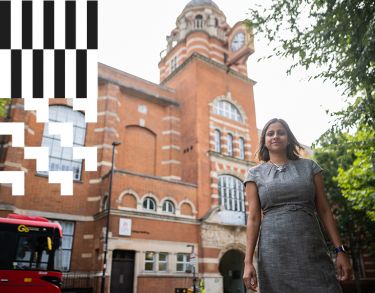 A City alumna standing near College Building