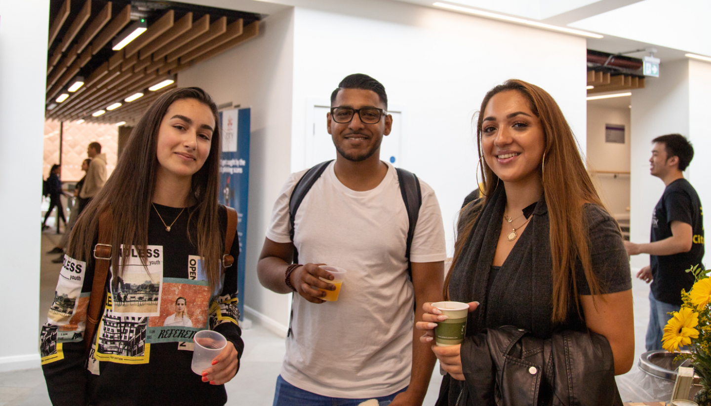 A group of three students at a Welcome event