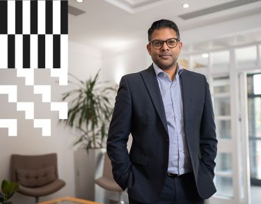 Picture of a City alumnus at an office reception