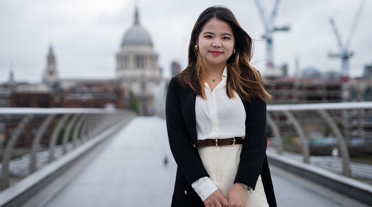 A City alumna standing at the Millennium Bridge
