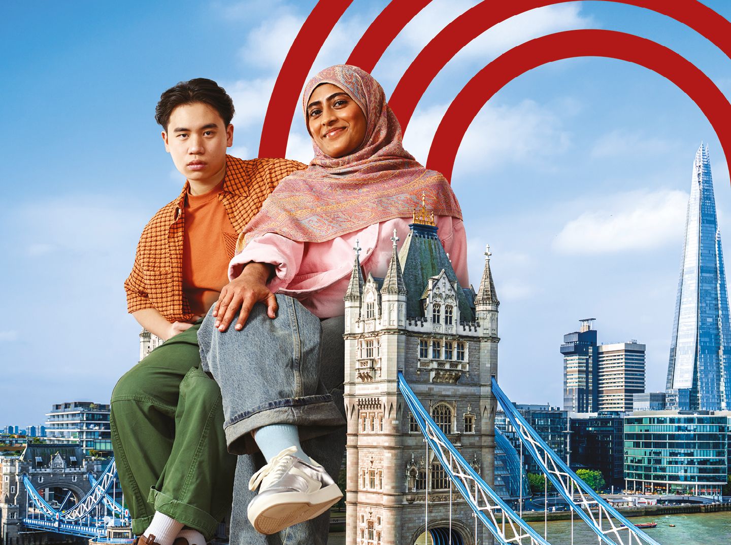 Two oversized students sitting atop a London landmark (Tower Bridge)