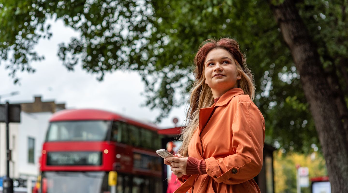 Student in front of London bus