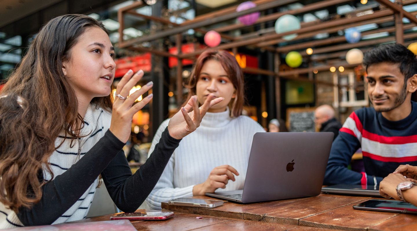 Three undergraduate students chatting