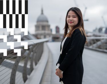 A City alumna standing at the Millennium Bridge